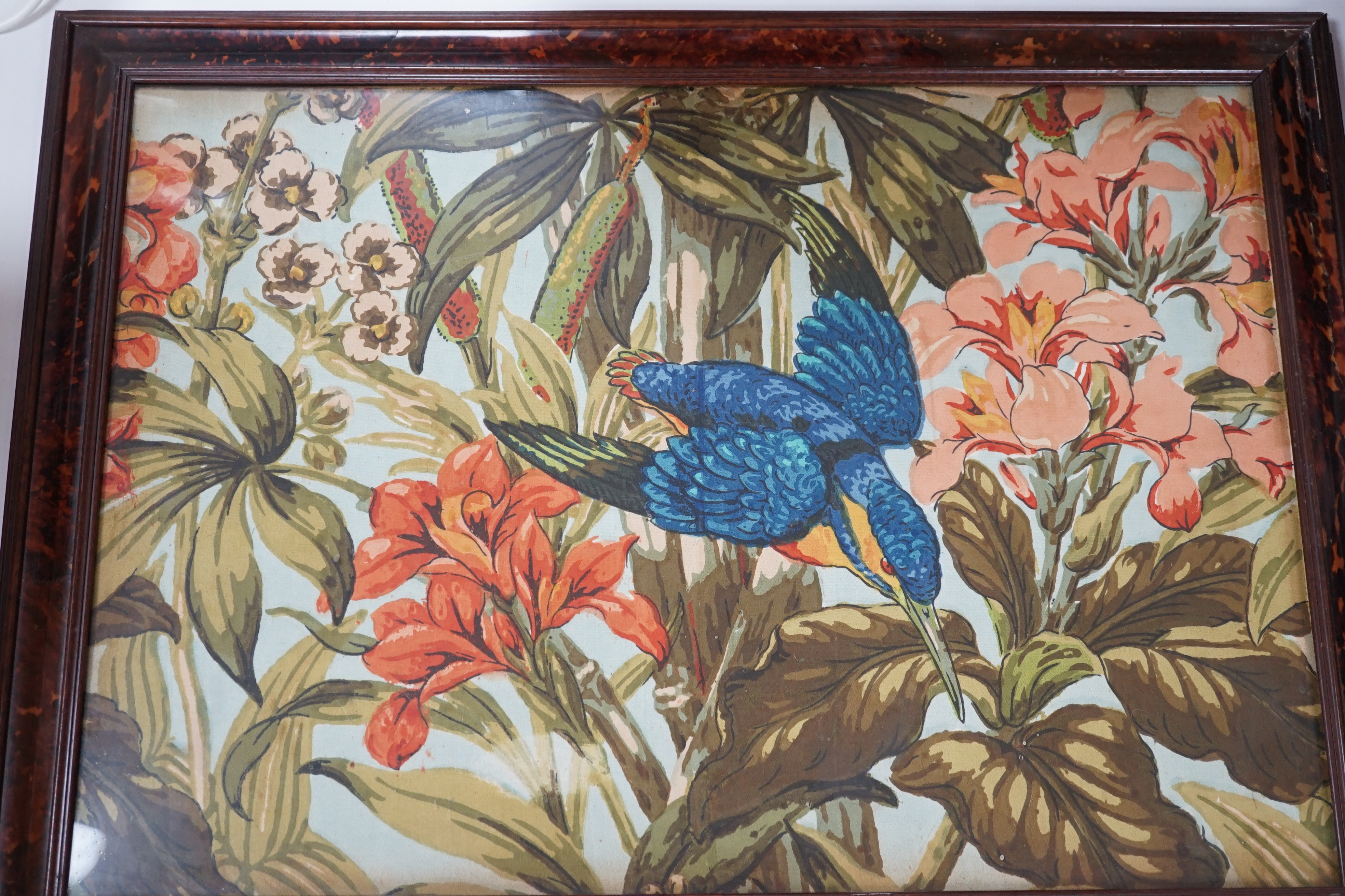 A large rare tortoiseshell picture frame and exotic panel of printed fabric, 70 cms wide x 52 cms high including frame